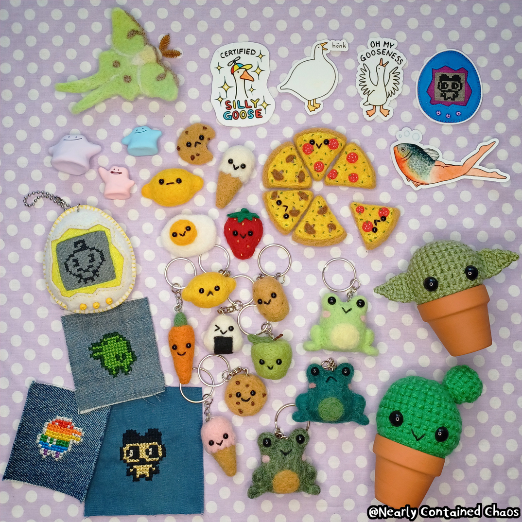 Assorted Nearly Contained Chaos handmade items on a lavender polka-dot background, including felted food keychains, crochet frogs and plants, embroidered patches, goose stickers, and other cute small crafts.