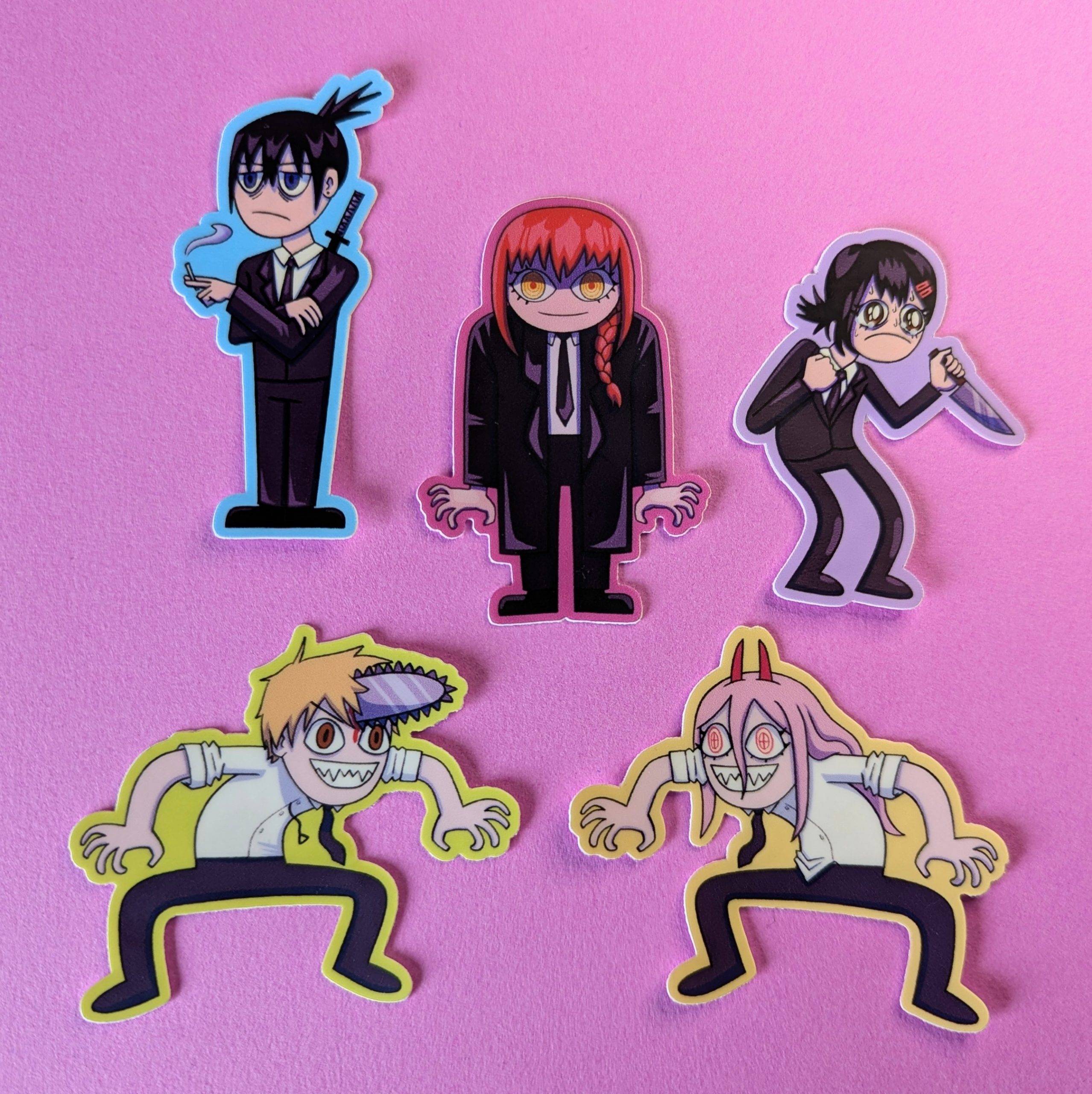 Five anime-inspired character stickers arranged on a pink background, including figures in black suits and exaggerated monster-like poses.