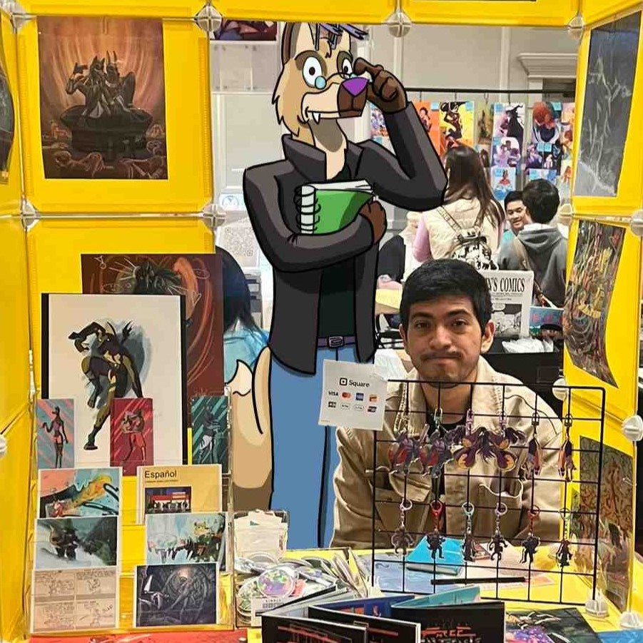 The Living Canvas Entertainment vendor table with bright yellow display panels, art prints, keychains, comics, and a large illustrated character standee behind the artist.