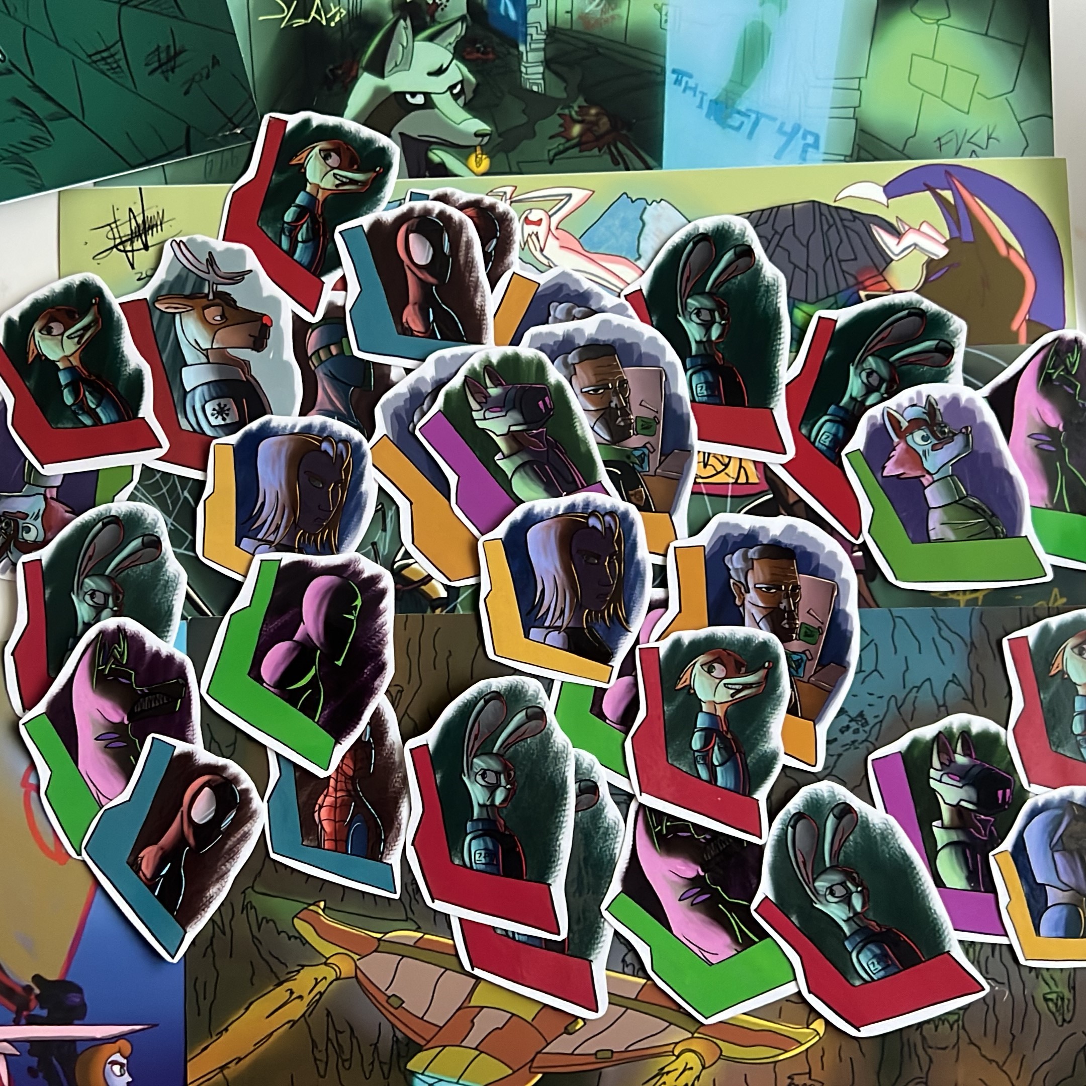 Close-up of colourful character stickers and postcard-style art prints featuring original fantasy and sci-fi animal characters.