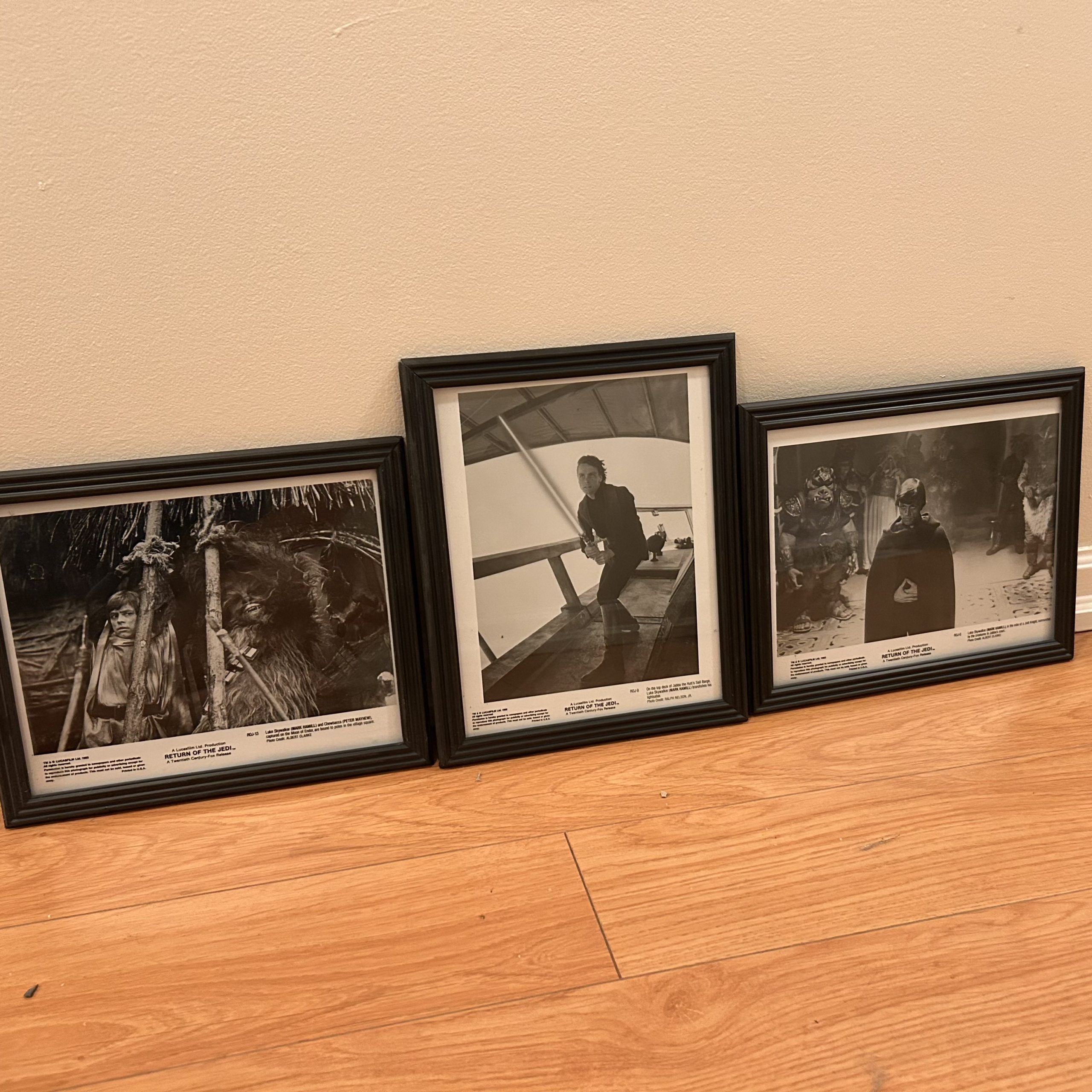 Three framed black-and-white Return of the Jedi film press photos, including Ewok village, Death Star, and Jabba’s palace scenes.