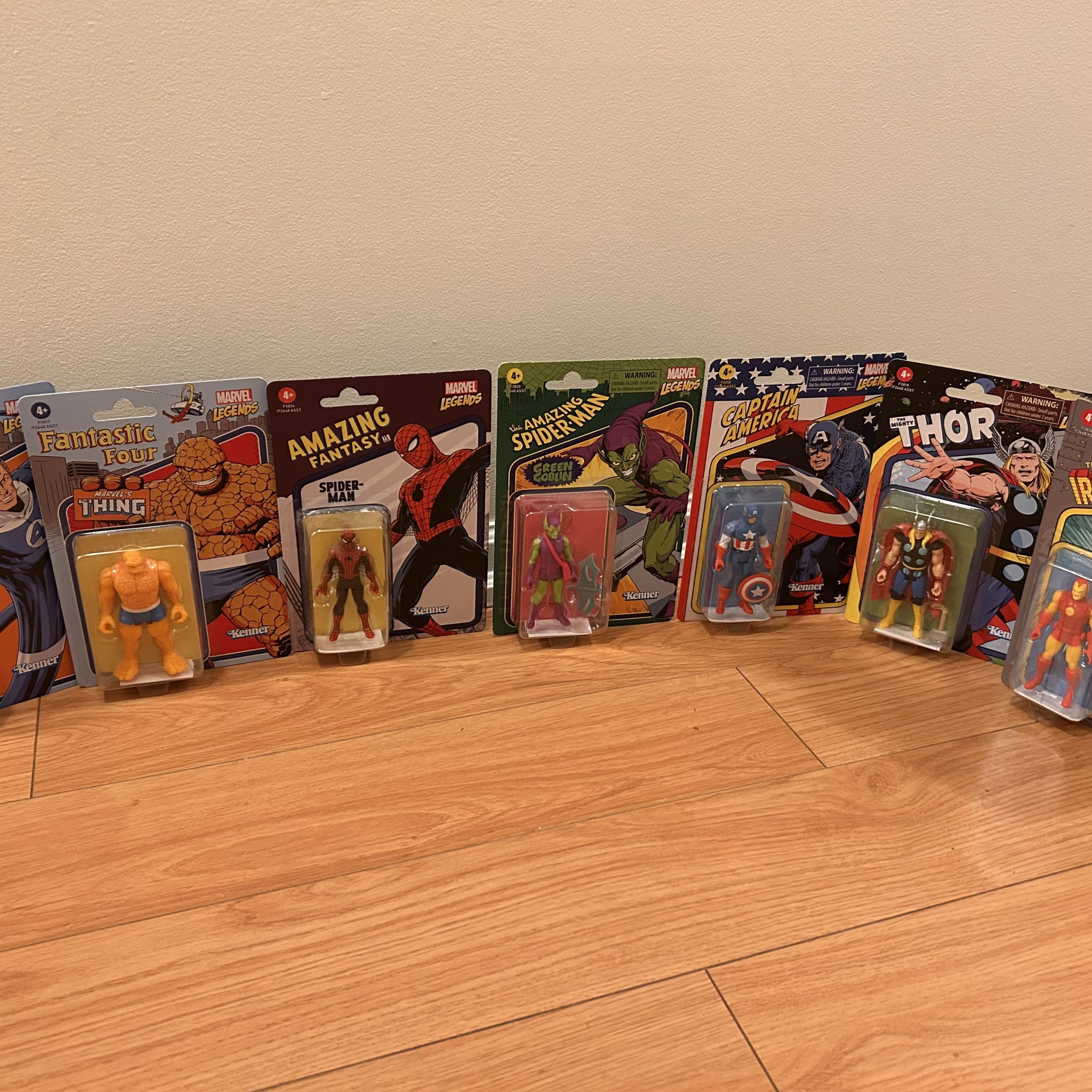 Row of carded retro Marvel action figures, including The Thing, Spider-Man, Green Goblin, Captain America, Thor, and Iron Man.