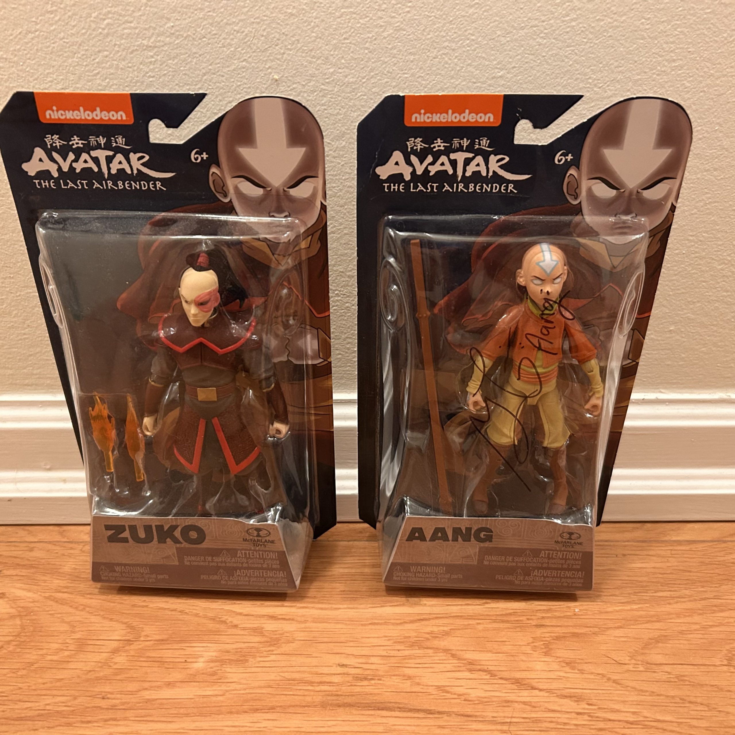 Two boxed Avatar: The Last Airbender action figures, Zuko and Aang, still in their original packaging, with Aang’s box signed across the front.
